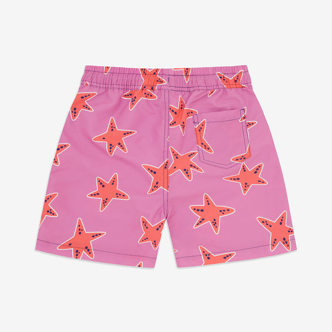 Pink starfish UV protective swim shorts. Pink shorts with a starfish pattern and a rear pocket, against a white background.